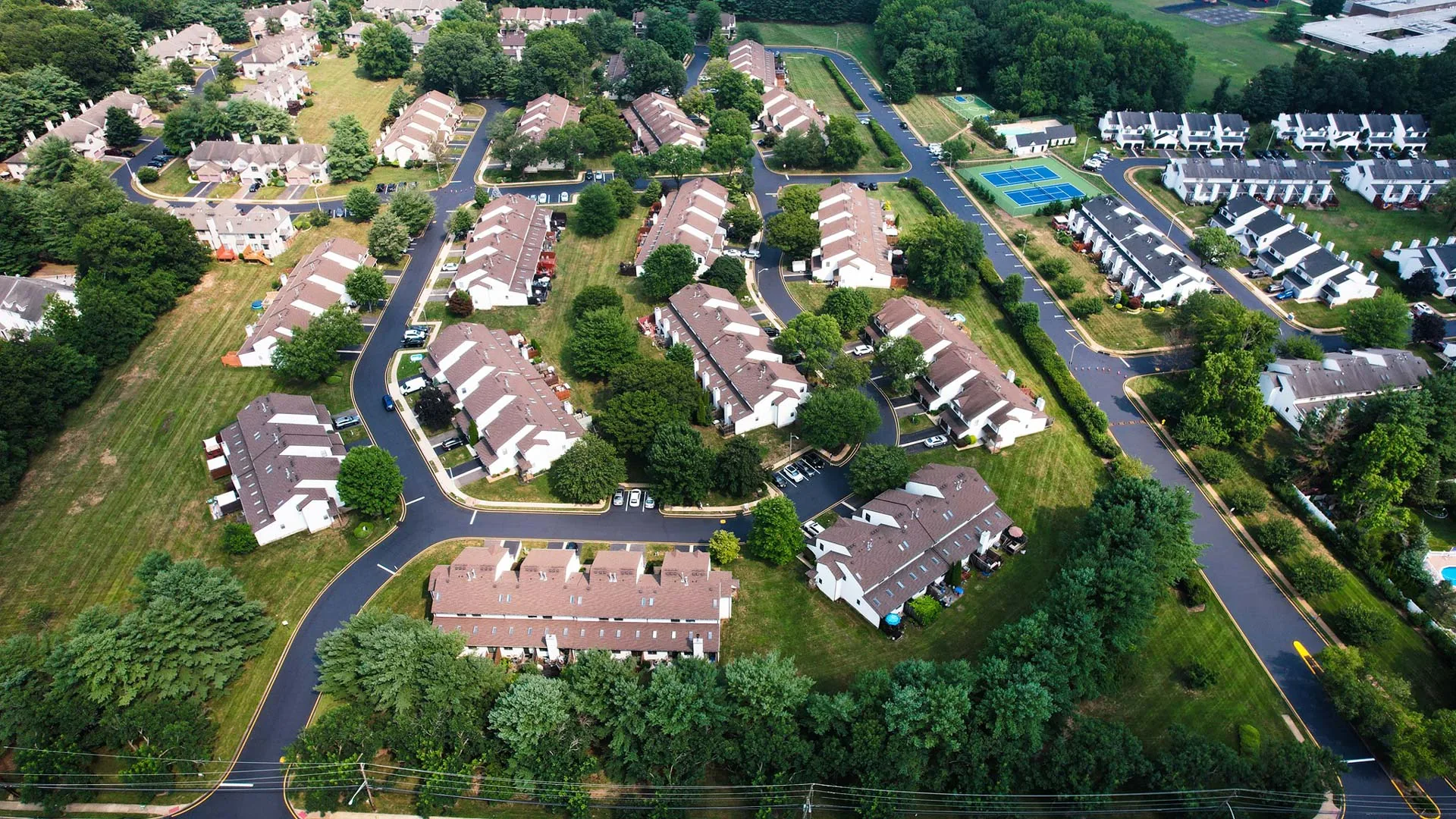 aerial view of apartment complexes and tennis courts