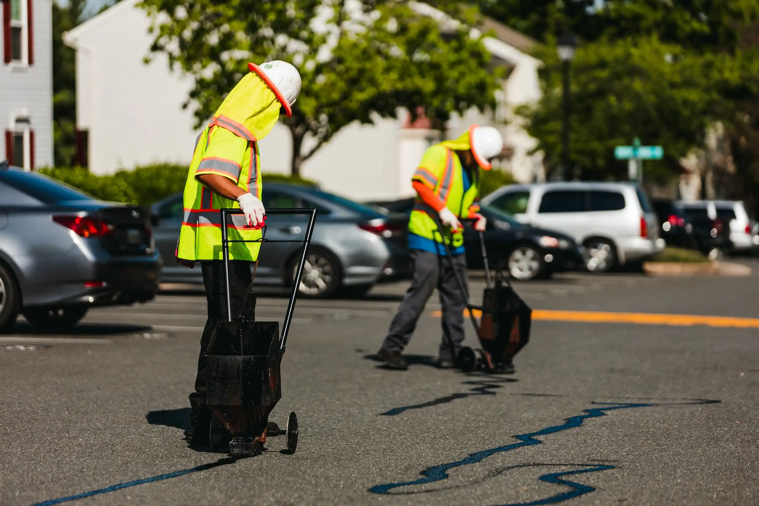 pave america employees sealing cracks in pavement