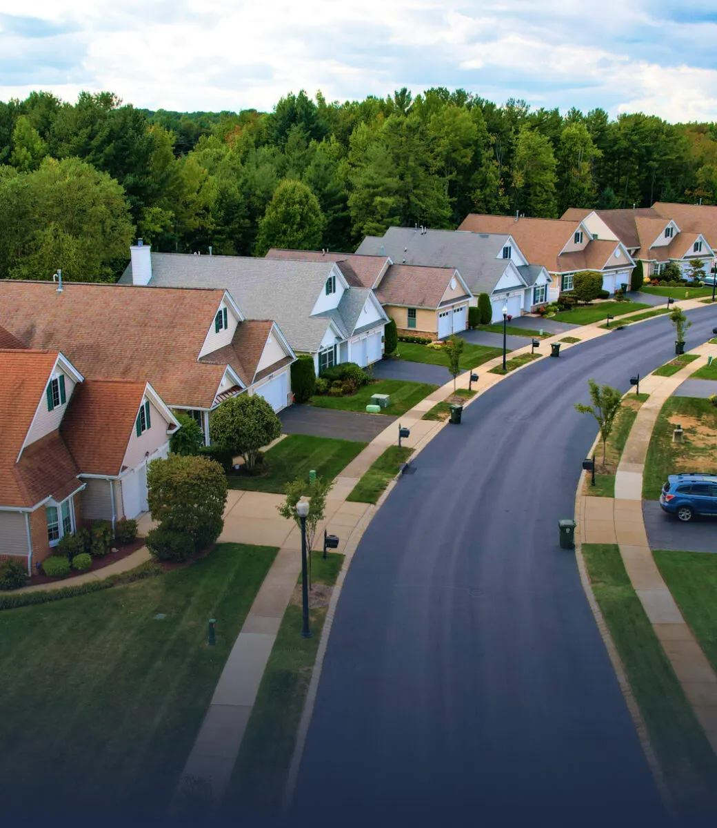a row of homes and a curving street