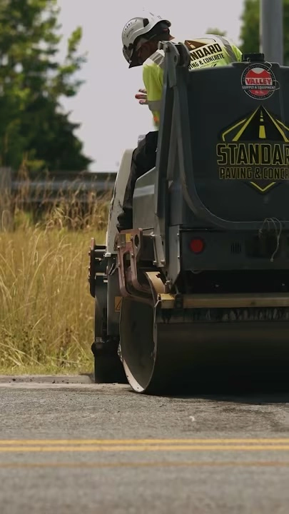 standard paving employee on an asphalt roller