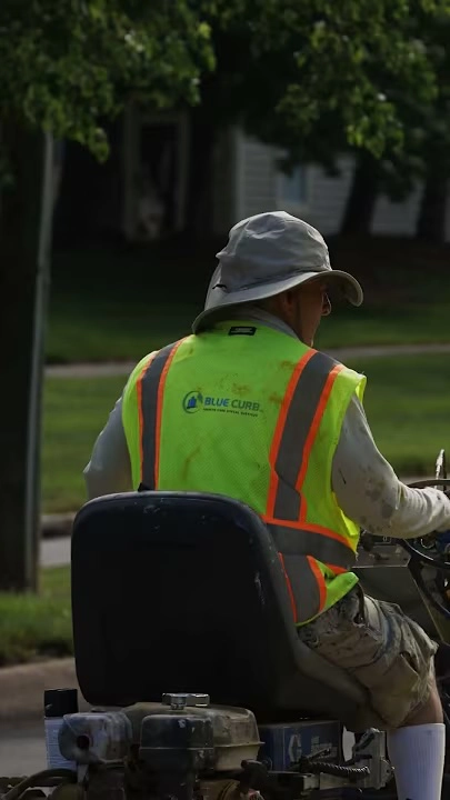back of a blue curb employee