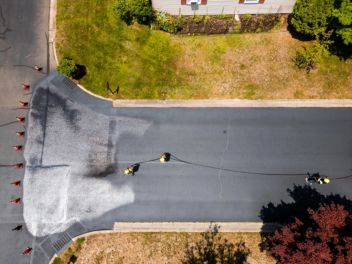 aerial view of Pave America employees sealcoating a street