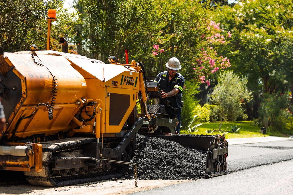 Pave america employee spreading asphalt