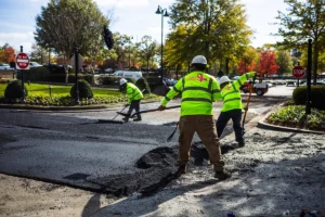 pave america employees raking asphalt